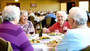 happy seniors enjoying a meal in the dining hall of a senior living community