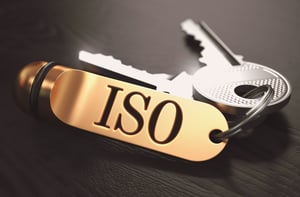 ISO 9001 - International Organization for Standardization - Concept. Keys with Golden Keyring on Black Wooden Table. Closeup View, Selective Focus, 3D Render. Toned Image.