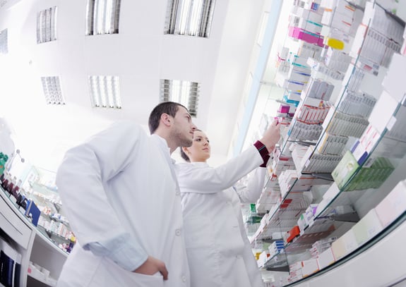 team of pharmacist chemist woman and man group standing in pharmacy drugstore