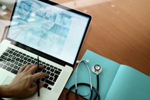 Doctor using laptop to view data