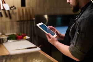 close-up-of-chef-in-uniform-holding-tablet-while-s-2023-05-12-02-07-50-utc
